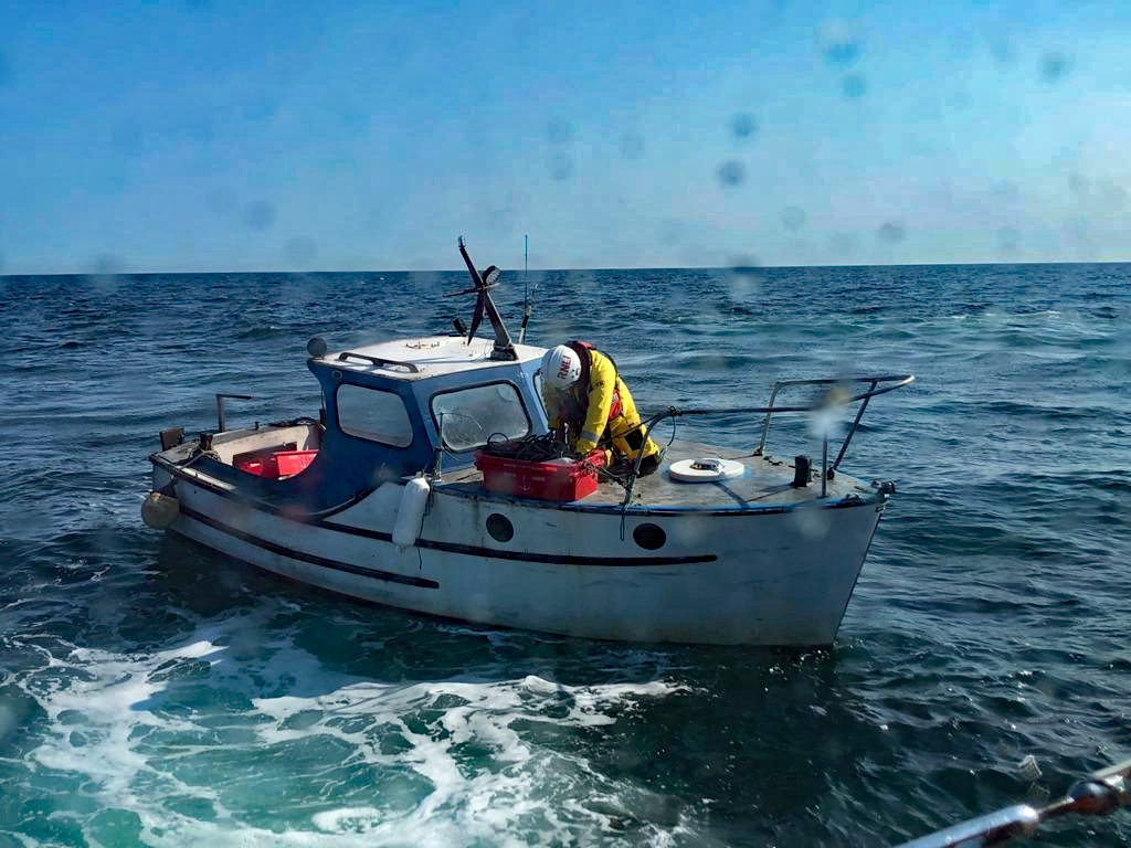 White and red flares summon help for disabled boat